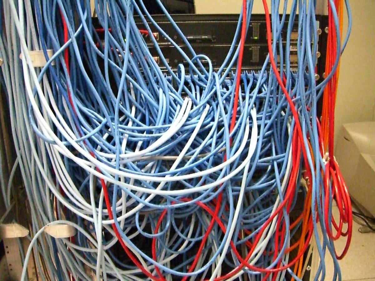 Propojovací panel v serverové skříni s množstvím síťových kabelů